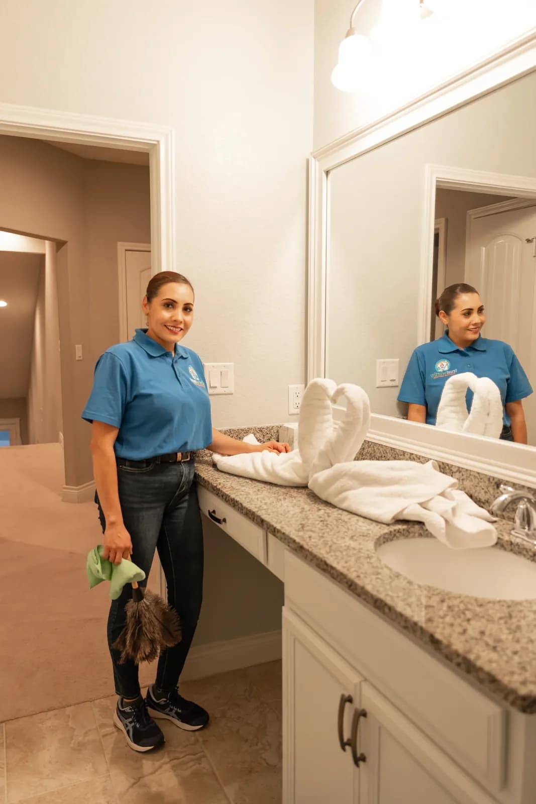 A Trustworthy cleaner polishing a bathroom vanity and mirror in Austin, TX