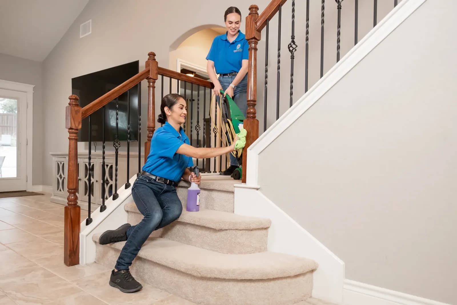 A Trustworthy cleaner cleaning a staircase handrail in an Austin, TX home